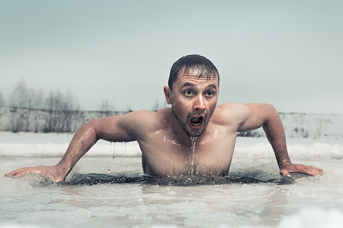 Man climbing out of frozen river